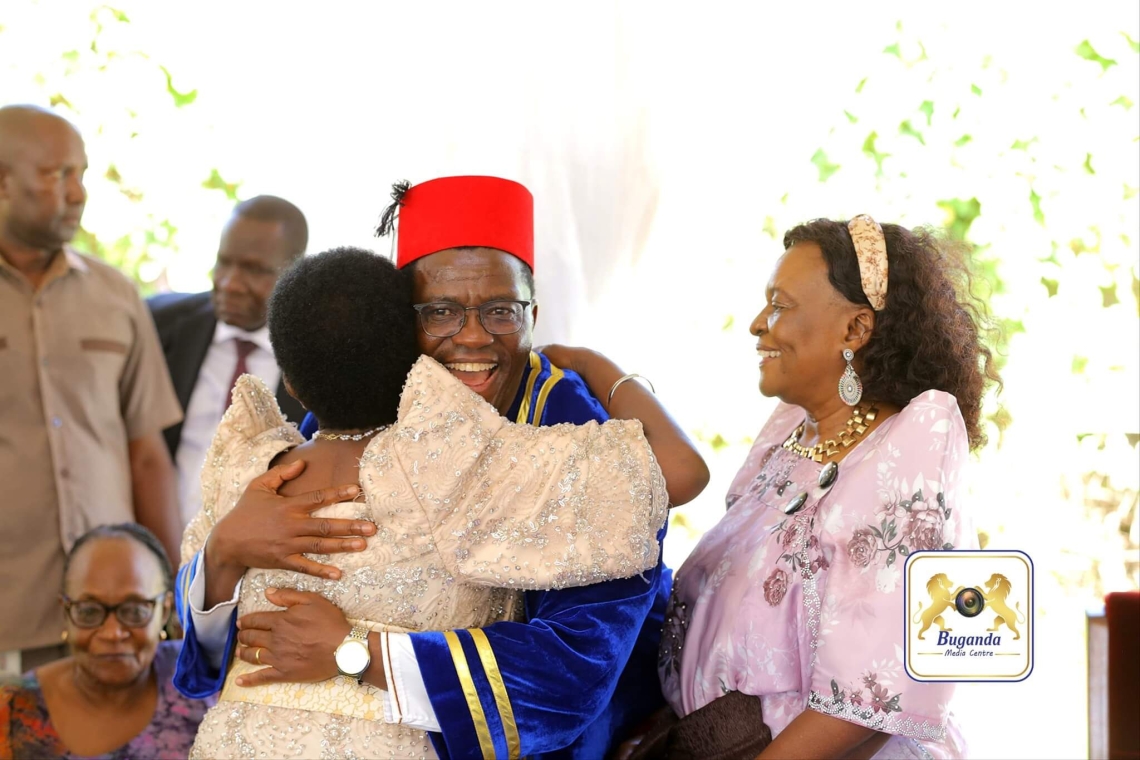  Katikkiro Mayiga being warmly congratulated with joy; on the left is his wife, beaming with pride and happiness